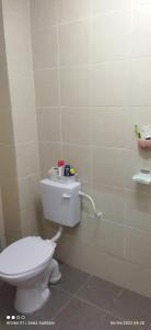 a bathroom with a white toilet in a room at D'Zara Homestay in Sepang +14 photos