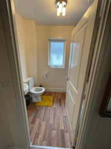 a bathroom with a toilet and a window at Holiday Home In Cardiff. Sleeps 6 in Cardiff +24 photos