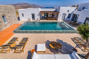a villa with a swimming pool and a house at Cape Ftelia in Elia