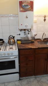 a kitchen with a counter with a mixer and a sink at Córdoba Te Espera in Córdoba