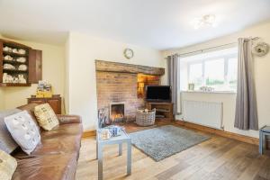 a living room with a couch and a fireplace at Ty Nant in Llanrwst