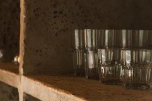 three empty glasses are sitting on a shelf at Casa Canoa - Praia de Algodões in Marau