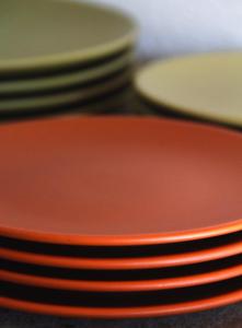 a stack of plates sitting on a table at Casa Canoa - Praia de Algodões in Marau