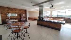 a restaurant with tables and chairs and a bar at Salvador Palace Hotel 