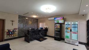 a grocery store with a soda machine and a tv at Salvador Palace Hotel 