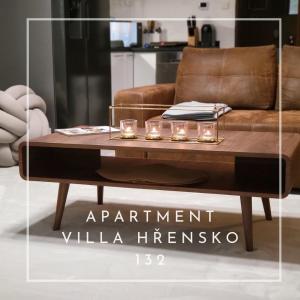 Apartment Villa Hřensko 132 في هرينسكو: طاولة قهوة أمام أريكة بنية