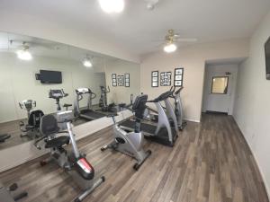 a gym with treadmills and elliptical machines at Governors Inn Hotel Sacramento in Sacramento