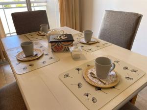 a table with two cups and plates on it at DESPERTAR in San Luis