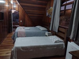 Un ou plusieurs lits dans un hébergement de l'établissement Casa do Trem Suítes
