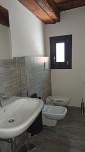 a bathroom with a sink and a toilet at Villa Piovene Apartments in Lonedo +35 photos