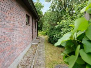 a brick building with a path next to a yard at 6 person holiday home in Højby-By Traum in Højby