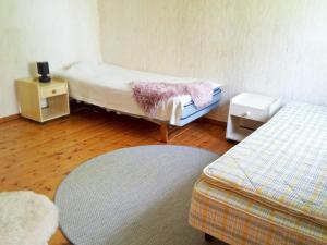 ルレオにあるHoliday home LULEÅのベッド2台とラグが備わる客室です。