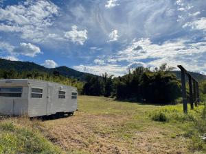 an rv parked in a field under a cloudy sky at GSM Bamboo Farm RV and Caravan site in Gundiah
