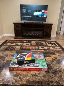 a living room with a television and a box at Nunaka Valley Cottage in Anchorage