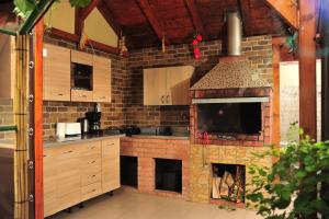 a kitchen with a brick oven with a fireplace at Casa Boby in Murighiol