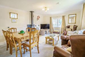 a living room with a wooden table and a couch at Ash Cottage in Llantwit Major