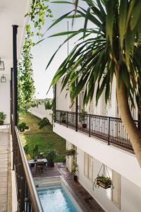 a view from the balcony of a hotel with a swimming pool at Brown Feather Hotel in Seminyak