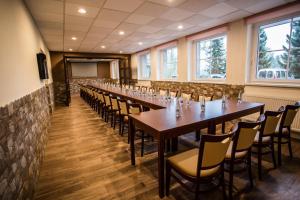 a conference room with long tables and chairs at Hotel Bon in Tanvald