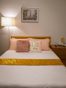 a bedroom with a bed with white sheets and pillows at LFCM Condo Home @ Mesatierra Residences Davao City in Davao City