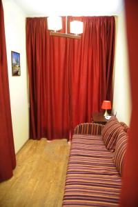 - un salon avec un rideau rouge et un canapé dans l'établissement Apartment on Pushkinskaya 16, à Odessa