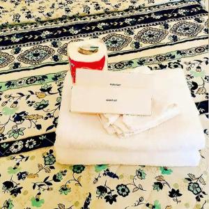 a envelope and a letter sitting on a bed at Jazkimronan Resort in Talisay