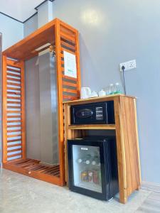 uma cozinha com um frigorífico ao lado de uma parede em Junlan Hotel em Sihanoukville