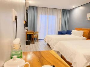 Postel nebo postele na pokoji v ubytování Junlan Hotel