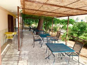 a group of tables and chairs under a pergola at Villa Sanja in Mimice