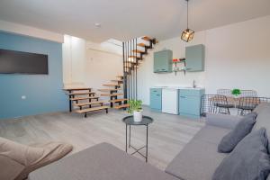 a living room with a couch and a kitchen at AGH Elite Apartments & Studios in Ohrid
