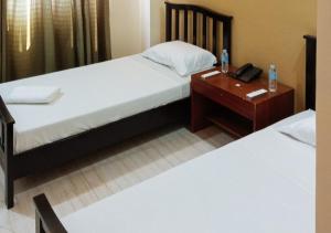 Postel nebo postele na pokoji v ubytování RedDoorz Plus @ Conclave Hotel Davao City