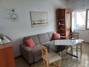 a living room with a couch and a table at Beach House in Betina