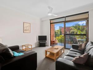 Sala de estar con 2 sofás y mesa de centro en Hawaiian Gardens Unit 22 en Coffs Harbour