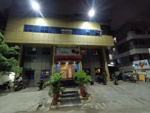 a building with motorcycles parked outside of it at night at GT Grande Hotel-Near US Consulate in Chennai