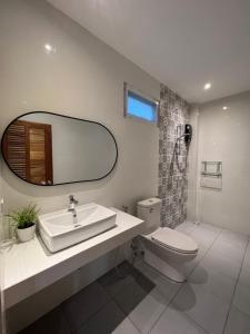 a bathroom with a sink and a toilet and a mirror at Pico Samui in Bophut 