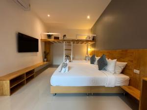 a hotel room with a bed and a television at Pico Samui in Bophut 