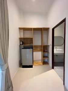 a room with a television and a refrigerator at Pico Samui in Bophut 