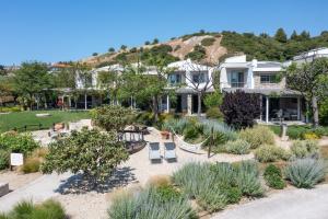 a house with a garden with a playground at Ammouda Villas in Ormos Panagias