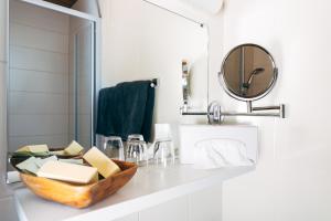 a bathroom with a wooden bowl on a counter with a mirror at Villa Blumegg in Hermagor +64 photos