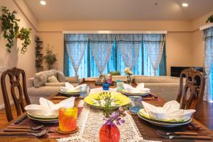 a dining room table with plates and dishes on it at Palm Villa Ishigakijima karei in Ishigaki Island +25 photos
