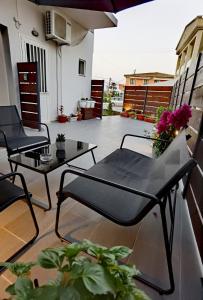 a patio with two chairs and a table on a balcony at Elia Room & Garden II (new entry) in Kontokali