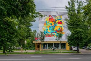 a building with a painting on the side of it at Nėris Inn Terraces in Vilnius