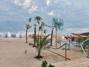 a playground on the beach with palm trees at Apartament Holiday in Mamaia Nord