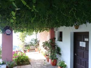 un bâtiment blanc avec une porte et quelques plantes dans l'établissement Villa Horizon, à Tsagkarada