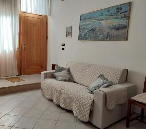 a living room with a couch in front of a door at Rental House in Cisternino in Cisternino