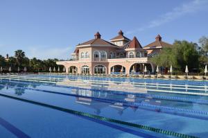 a large swimming pool in front of a house at Sirene Belek Hotel in Belek