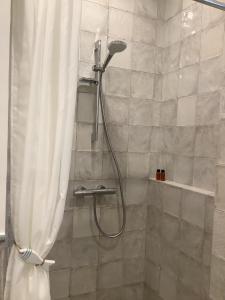 a bathroom with a shower with a shower curtain at Vila MAY in Juodkrantė +25 photos