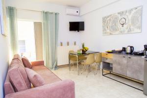 a living room with a couch and a table and a kitchen at Marietta City Center Apartment Nafplio Near Old Town & Arvanitia Beach in Nafplio