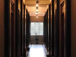 a hallway with black curtains and a window at Lake Side Resort Neermahal in Melāghar