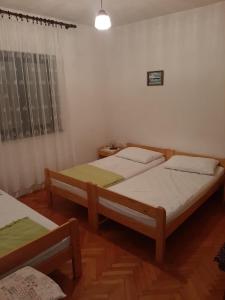 a bedroom with two beds and a window at Norma 2 in Novigrad Istria