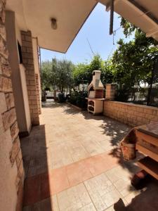 an outdoor patio with a table and a grill at Norma 2 in Novigrad Istria